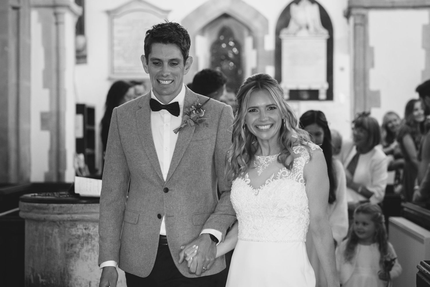 A couple stands together at the altar during their wedding ceremony in a church.
