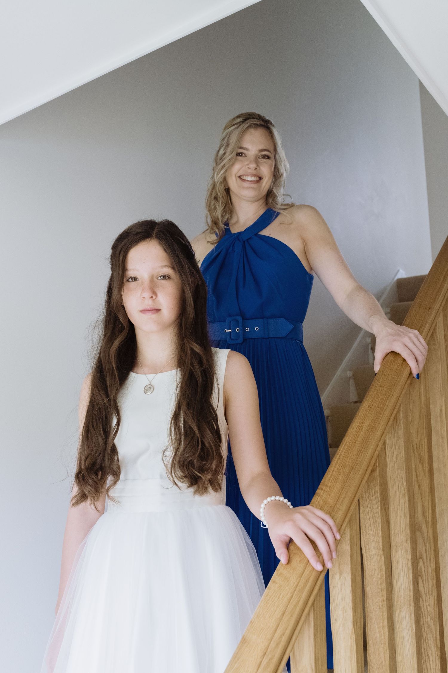 Two women standing on the stairs for a wedding