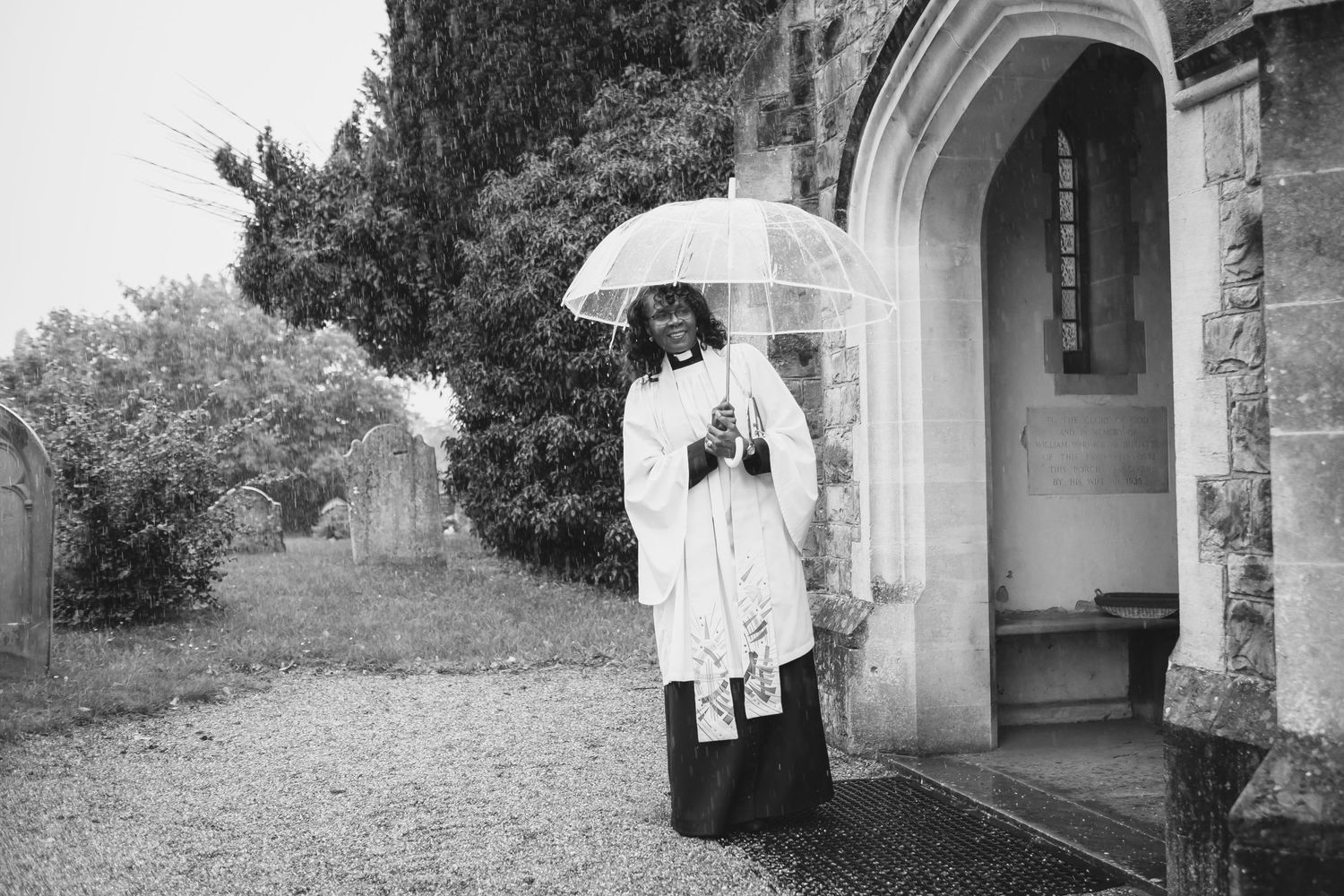 Vicar waiting outside the church in the rain
