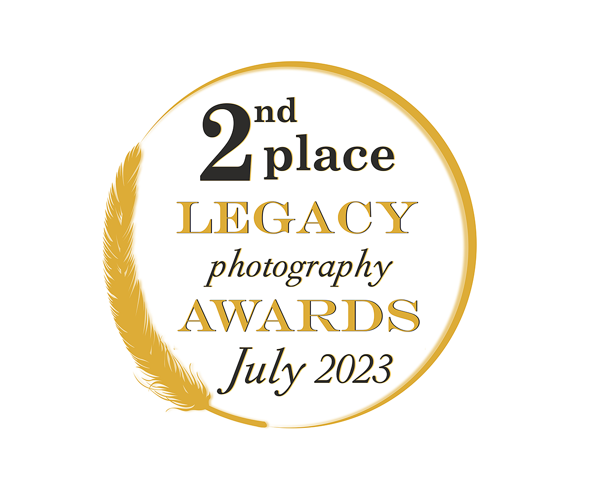 A circular award badge with gold wheat accents showing '2nd place Legacy Photography Awards July 2023'.