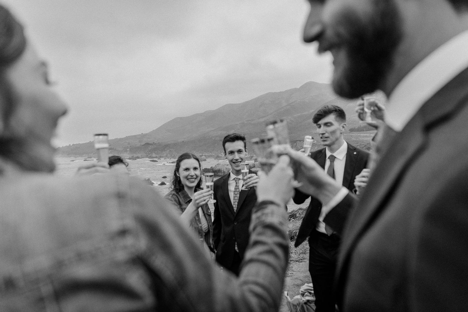 Guests gather for an intimate outdoor celebration with drinks and laughter.