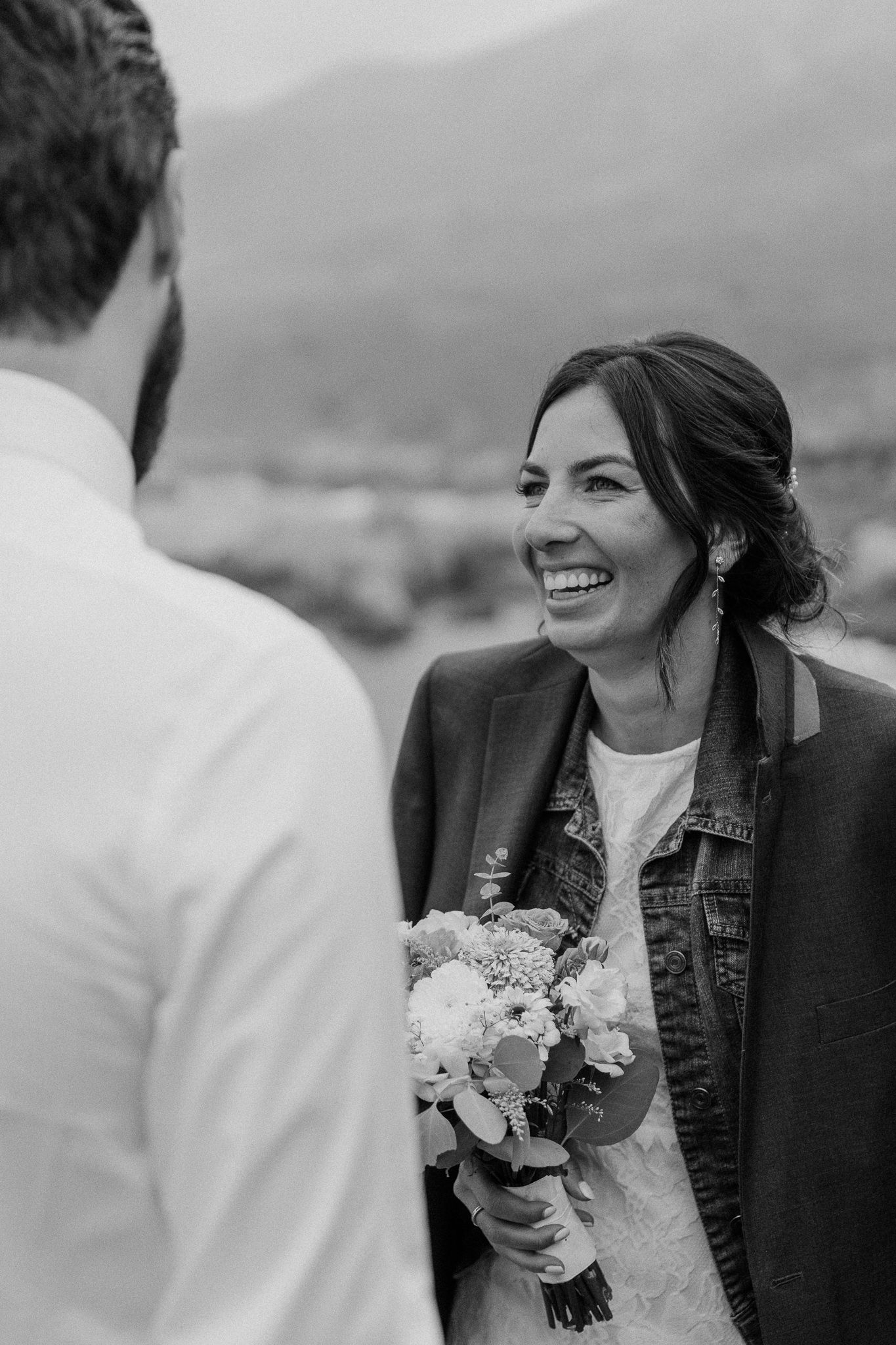 A candid moment of joy during an outdoor wedding celebration.