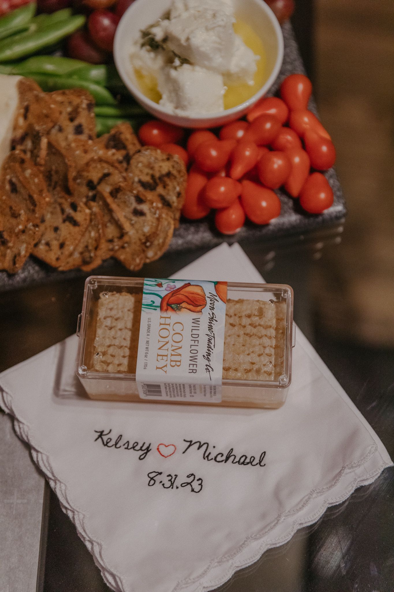 Wedding appetizer platter with crackers, vegetables and personalized napkin.