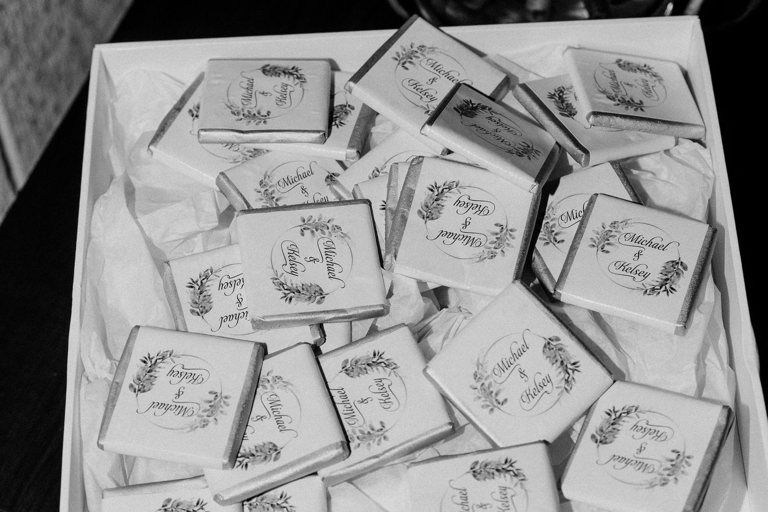 Black and white image of wedding favor cards arranged in a box.