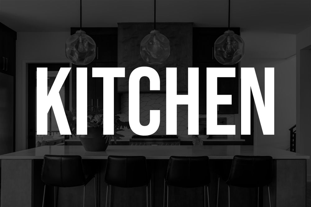 White KITCHEN text overlaid on monochrome image of modern kitchen with pendant lights.