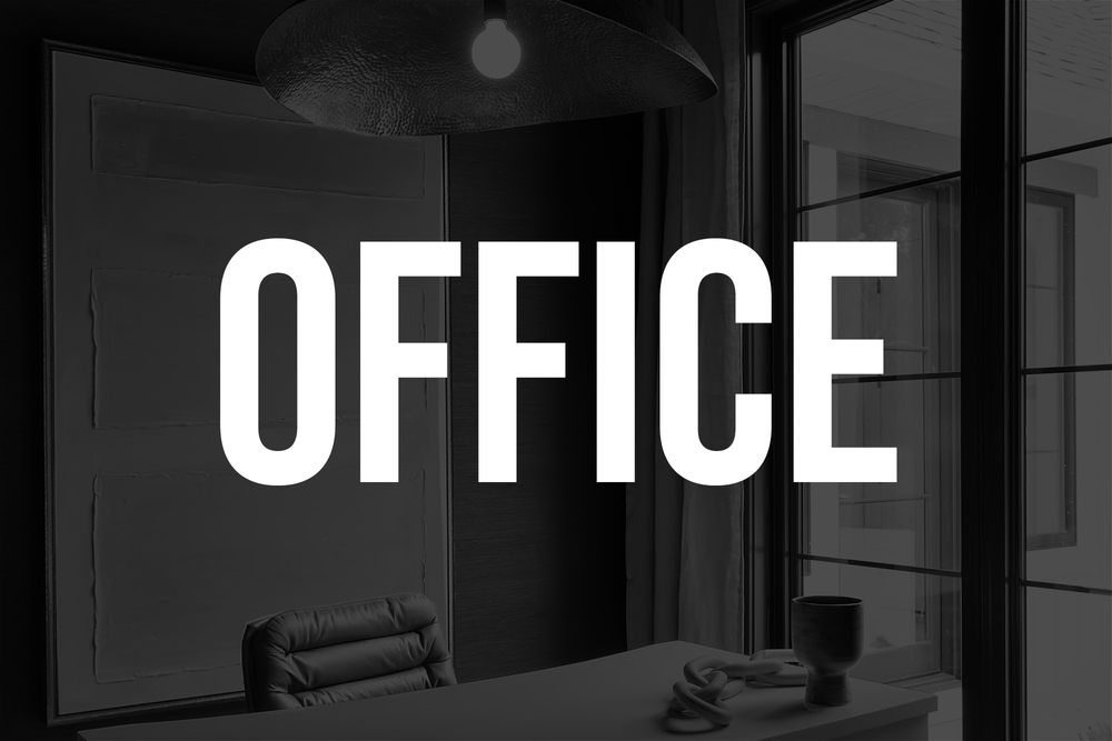 White OFFICE text overlaid on black and white image of modern office space.