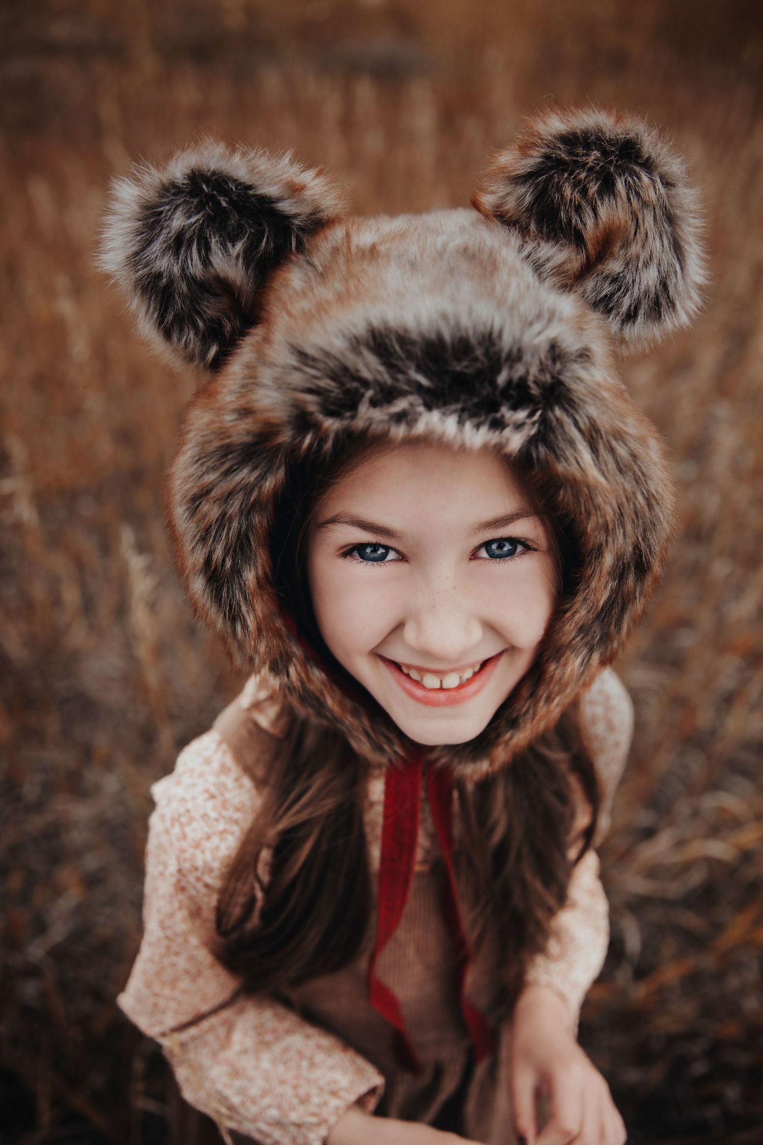 cute girl with bear hat smiling at camera