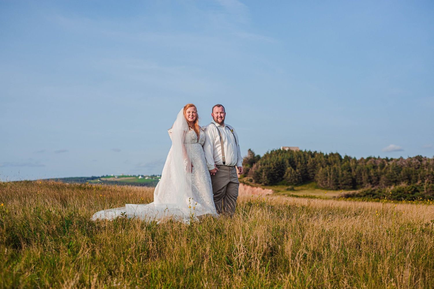 Bride and groom are photographed on a cliffside in Port Hood, Cape Breton, Nova Scotia.
