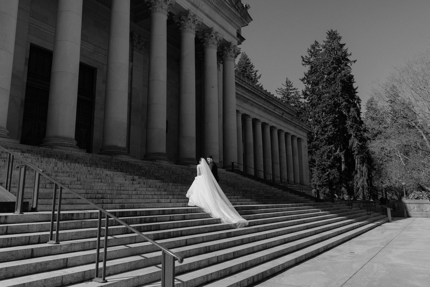 Photo of a Bride and Groom going up the stairs at the capitol building in Olympia