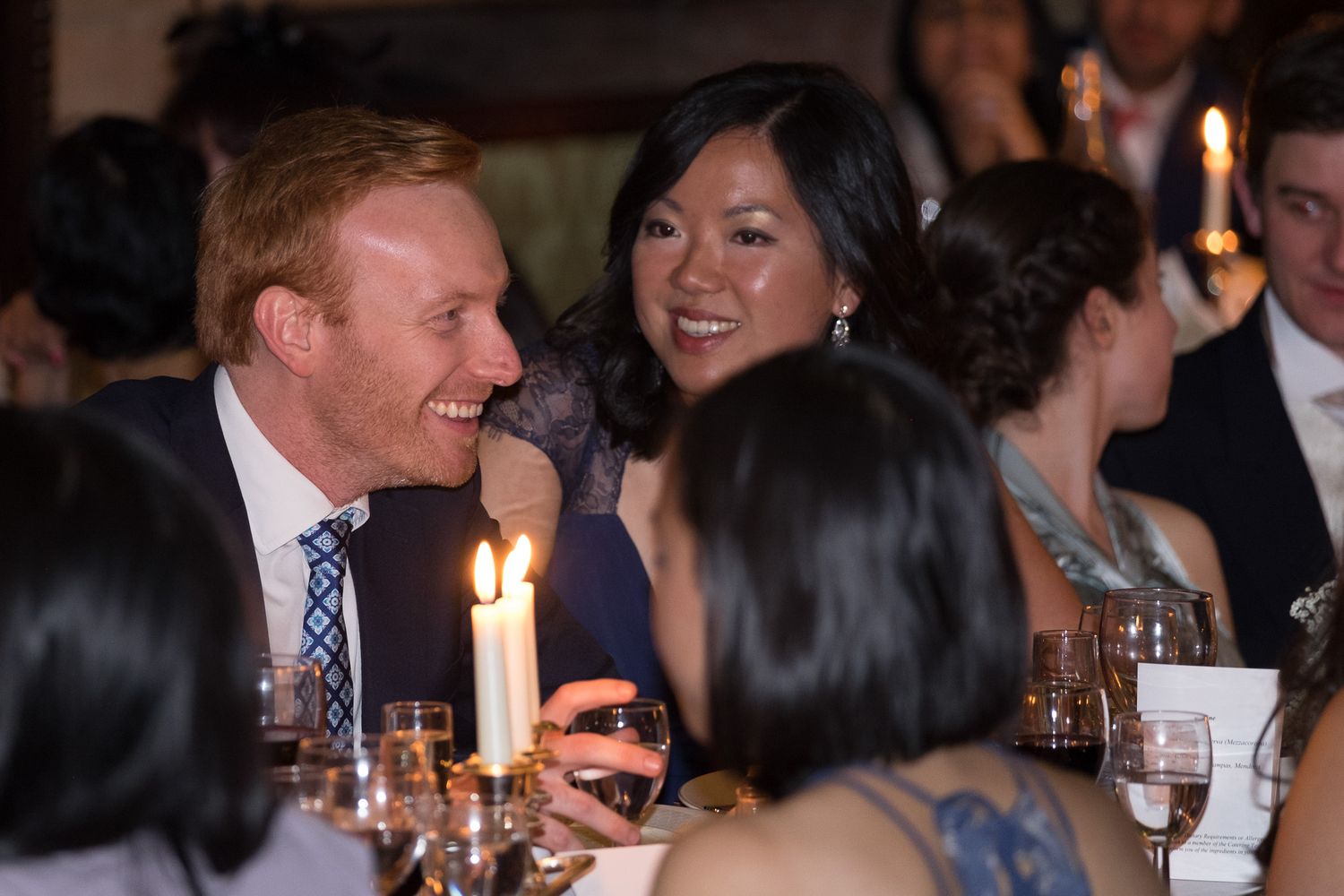 reportage capture of guests laughing at wedding breakfast
