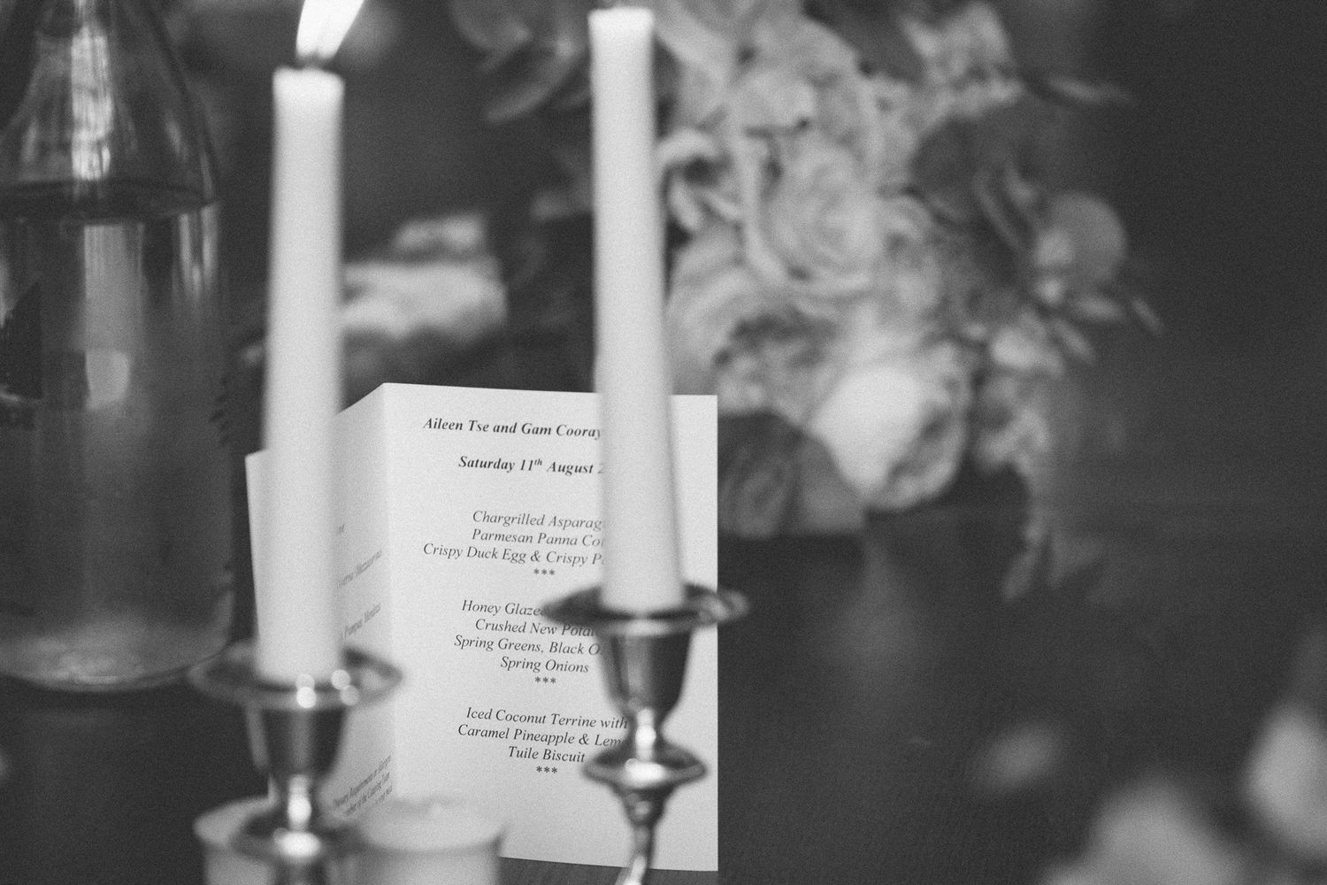 monochrome wedding detail of wedding card and candles