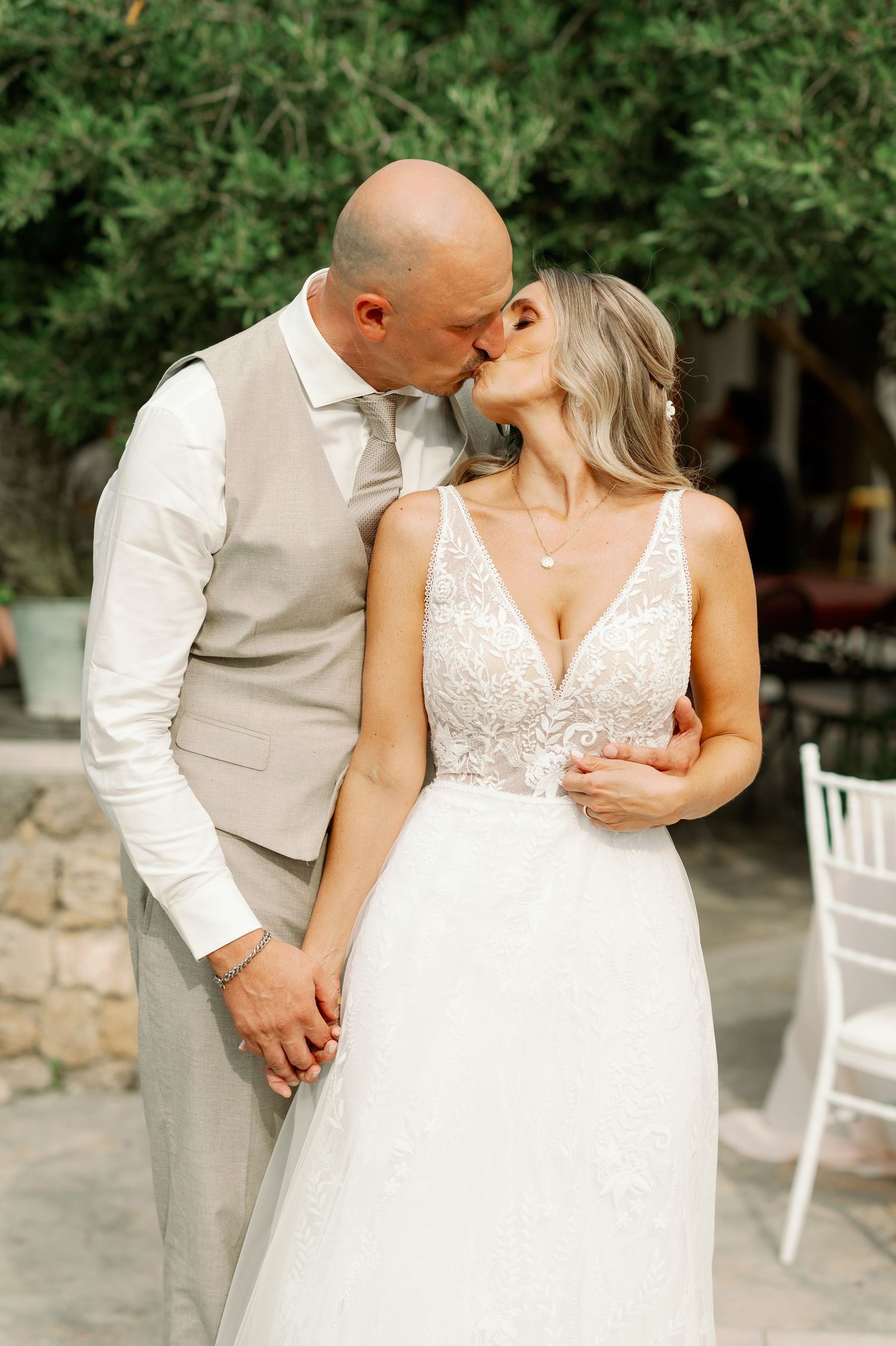 Intimate wedding portrait captured in outdoor garden setting.