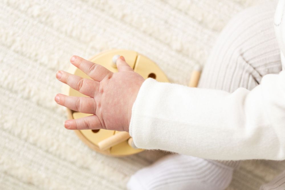 boys hand reaching for candles on the wooden cake in milestone session