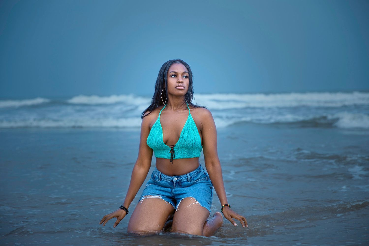 Beach photography series with turquoise accessories against ocean backdrop.