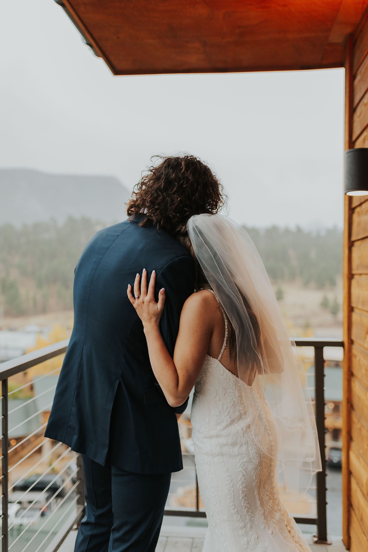 Bride and groom hugging and looking at the view