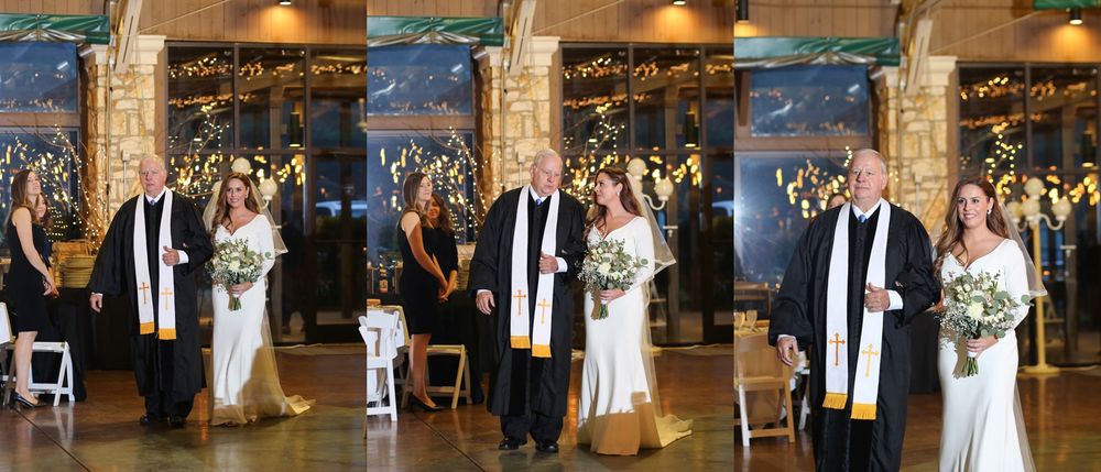 Indoor wedding ceremony setup with elegant stone pillars and chandelier lighting.