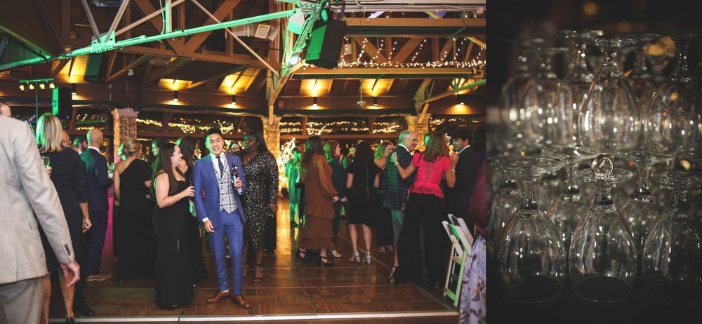 Party guests dance and socialize under industrial lighting at a reception venue.