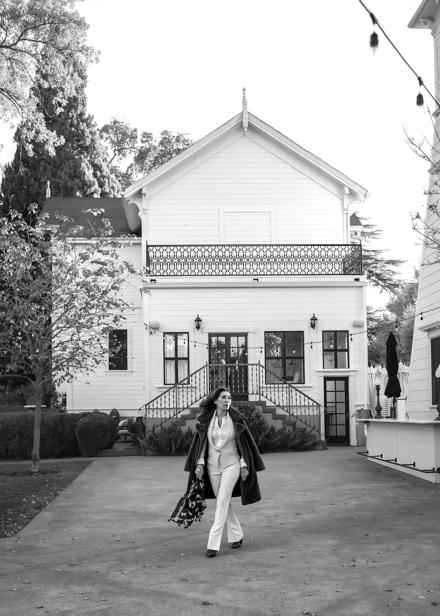 A stately woman walks in front of the main house at Park Winters