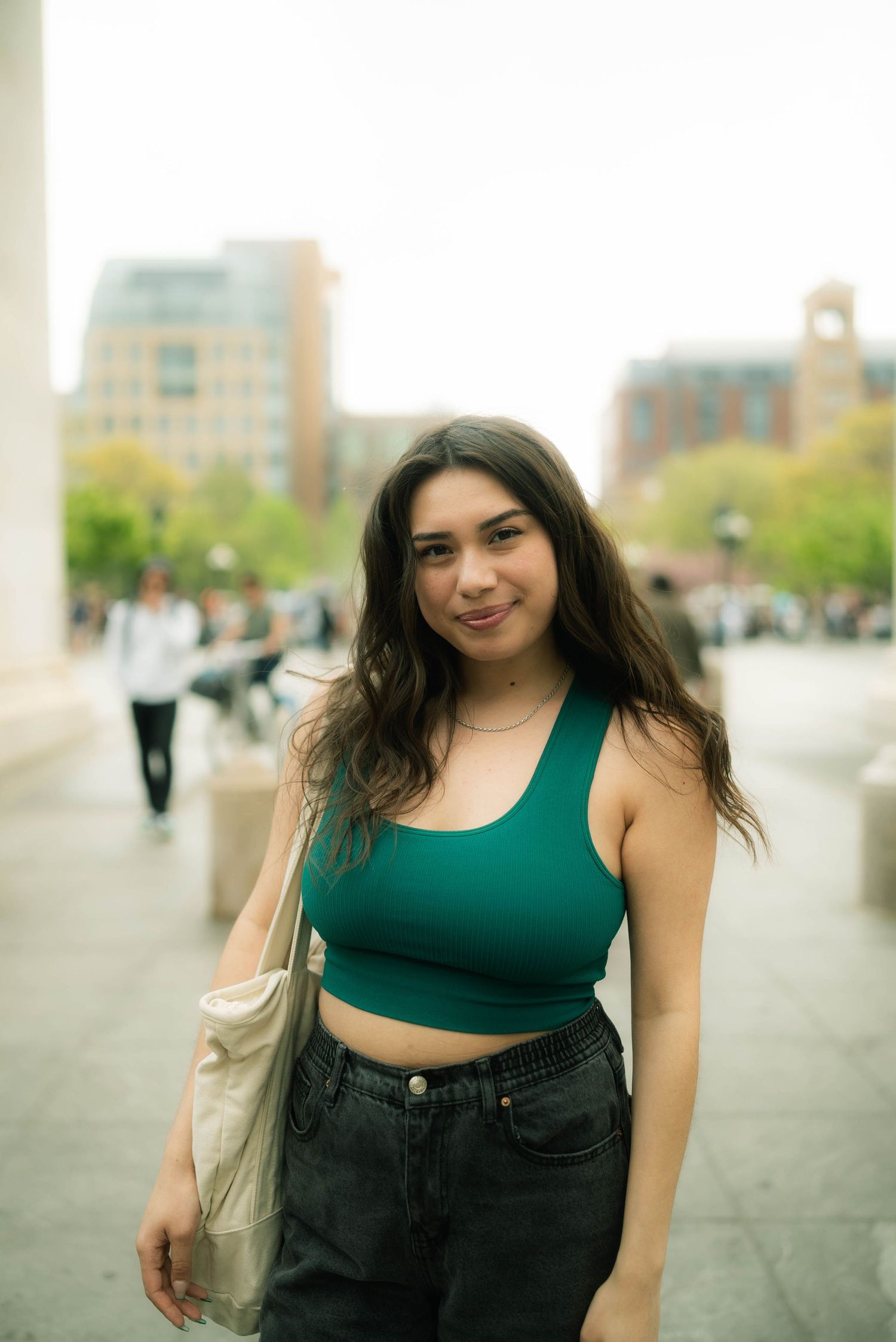 A sequence of casual street style photos featuring a green crop top and black jeans outfit.