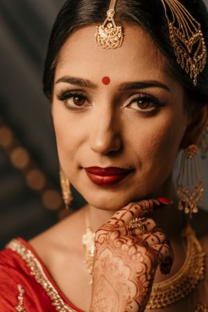 Traditional Indian bridal makeup and jewelry showcasing cultural wedding beauty.