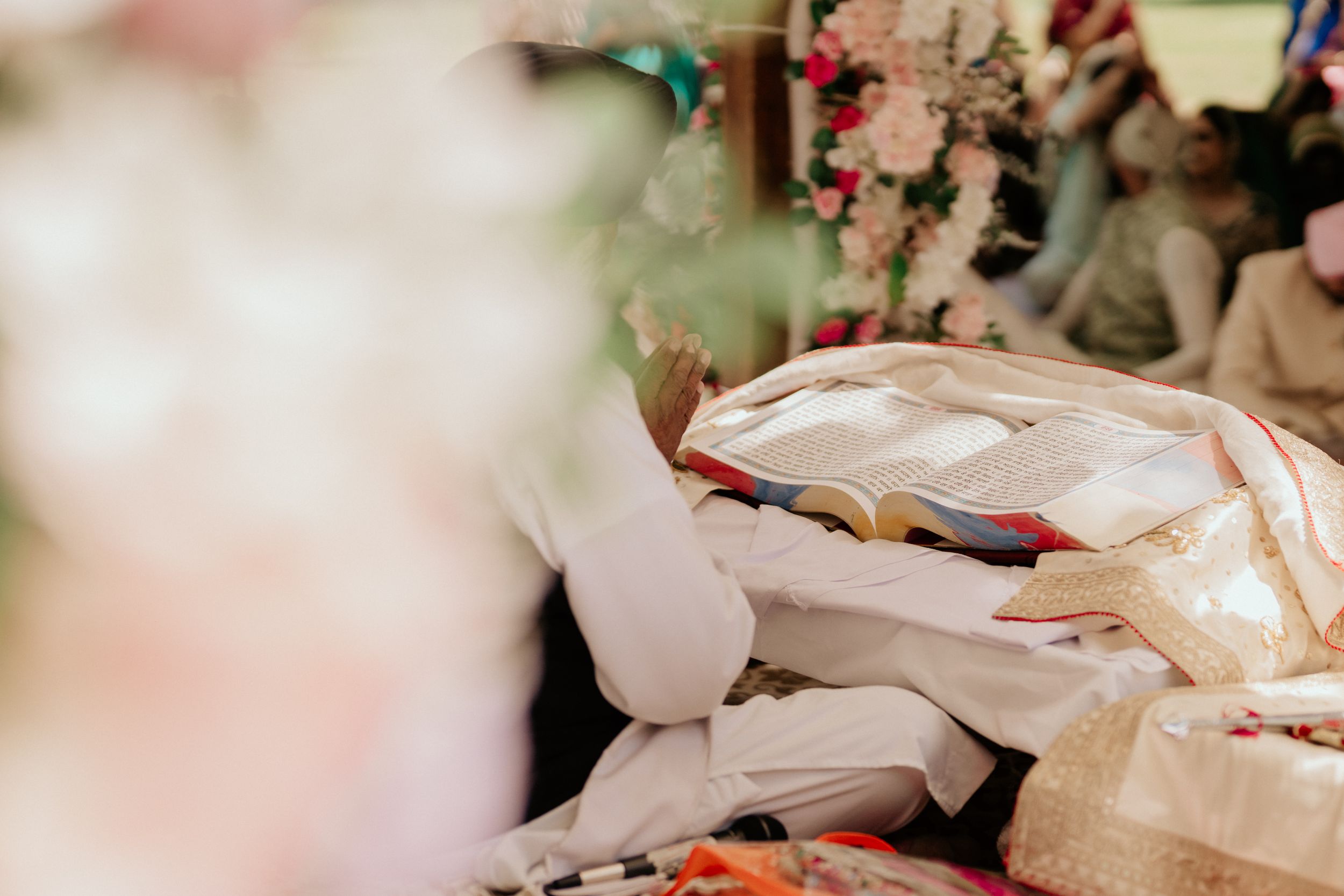 Close-up of ceremonial objects and textiles during traditional wedding ritual.