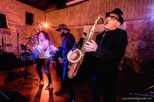 Wedding reception dance floor scenes with warm lighting in a rustic barn venue.