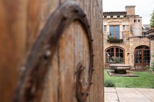 Rustic wooden beams and stone architecture details of a historic wedding venue.