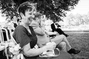 Wedding guests enjoying candid moments during an outdoor celebration.