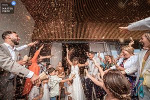 Celebratory moment captured with confetti flying through the air at an indoor venue.