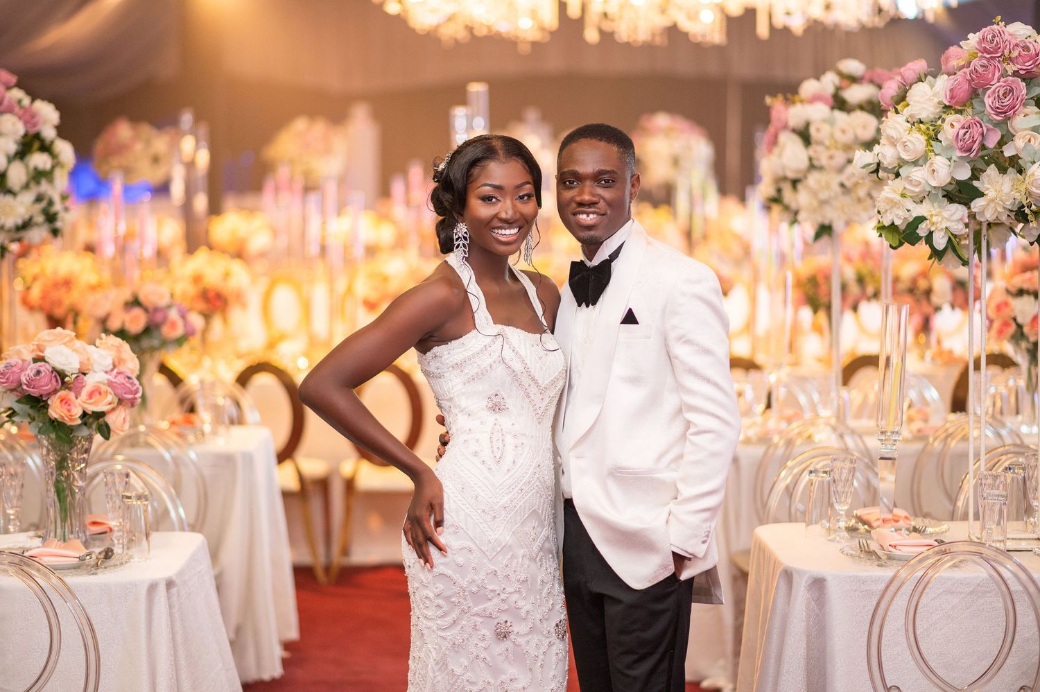 Elegant wedding reception setup with romantic lighting, floral arrangements, and crystal decor.