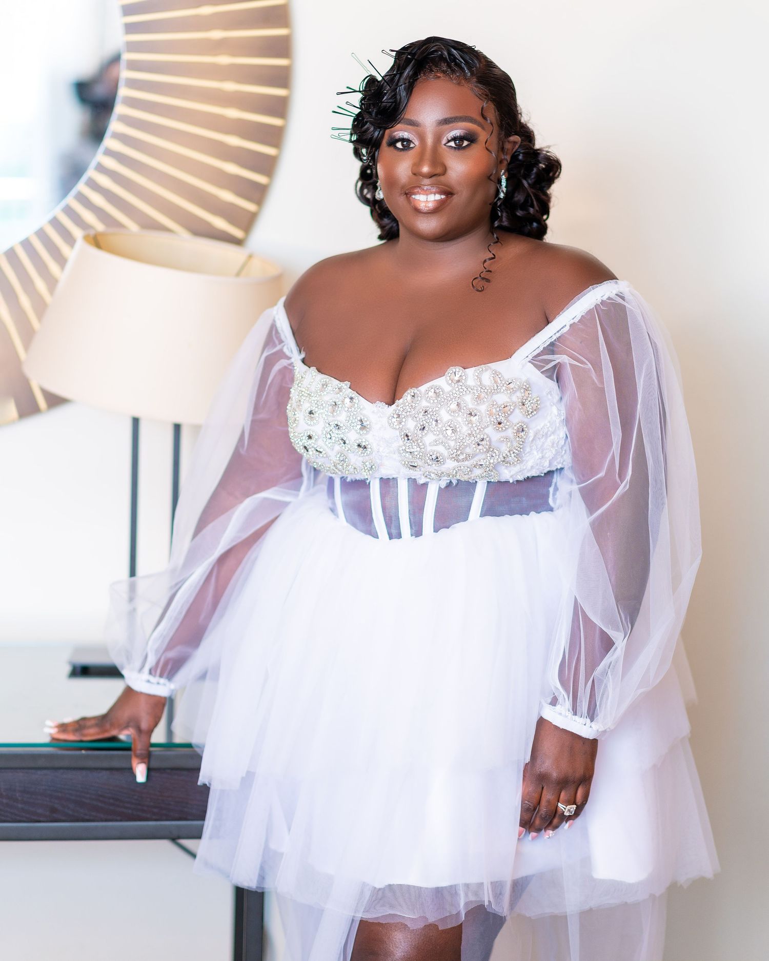 Bridal portraits showcasing flowing white tulle dress with sheer details and romantic styling.
