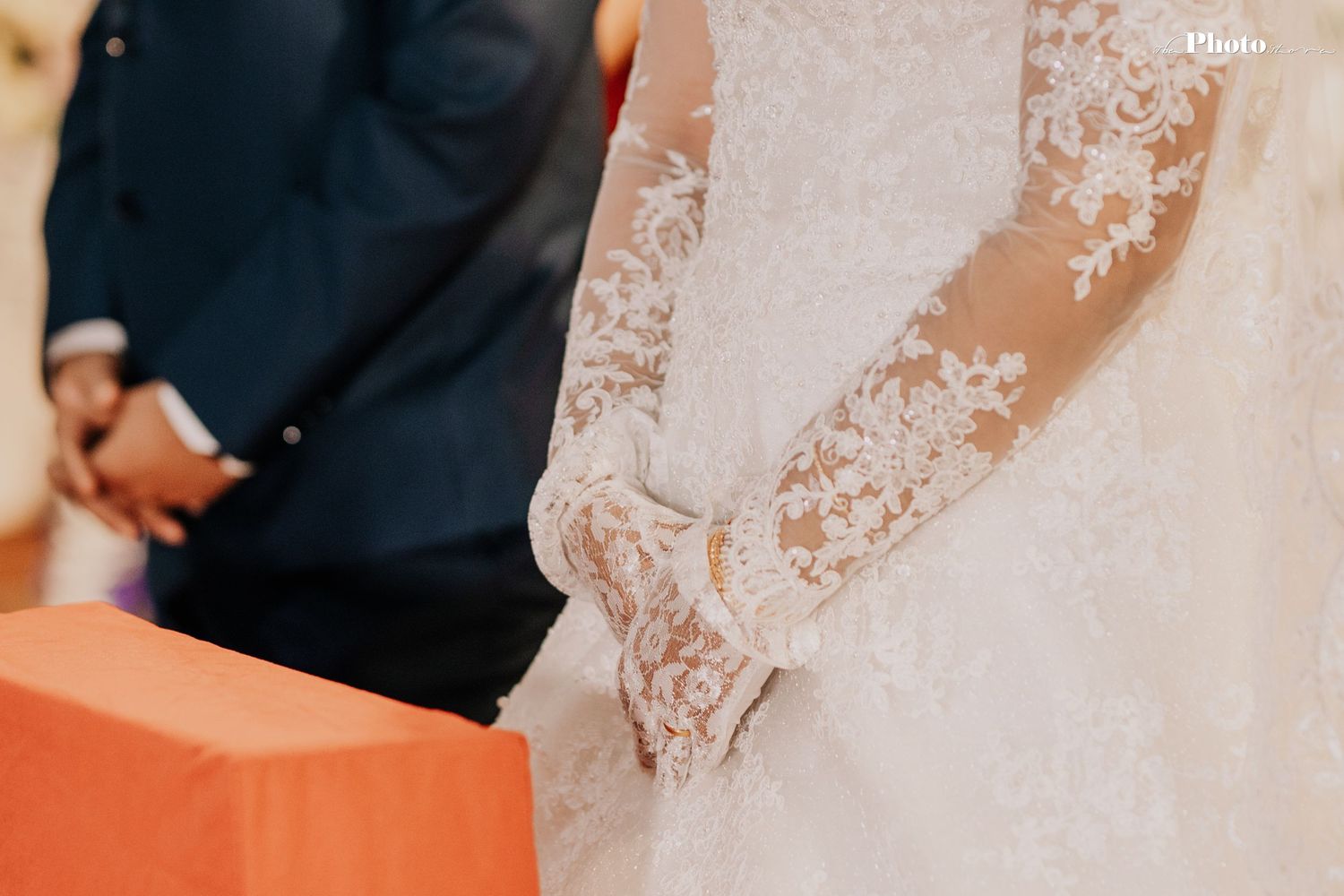 Close-up of intricate white lace details on a wedding dress.