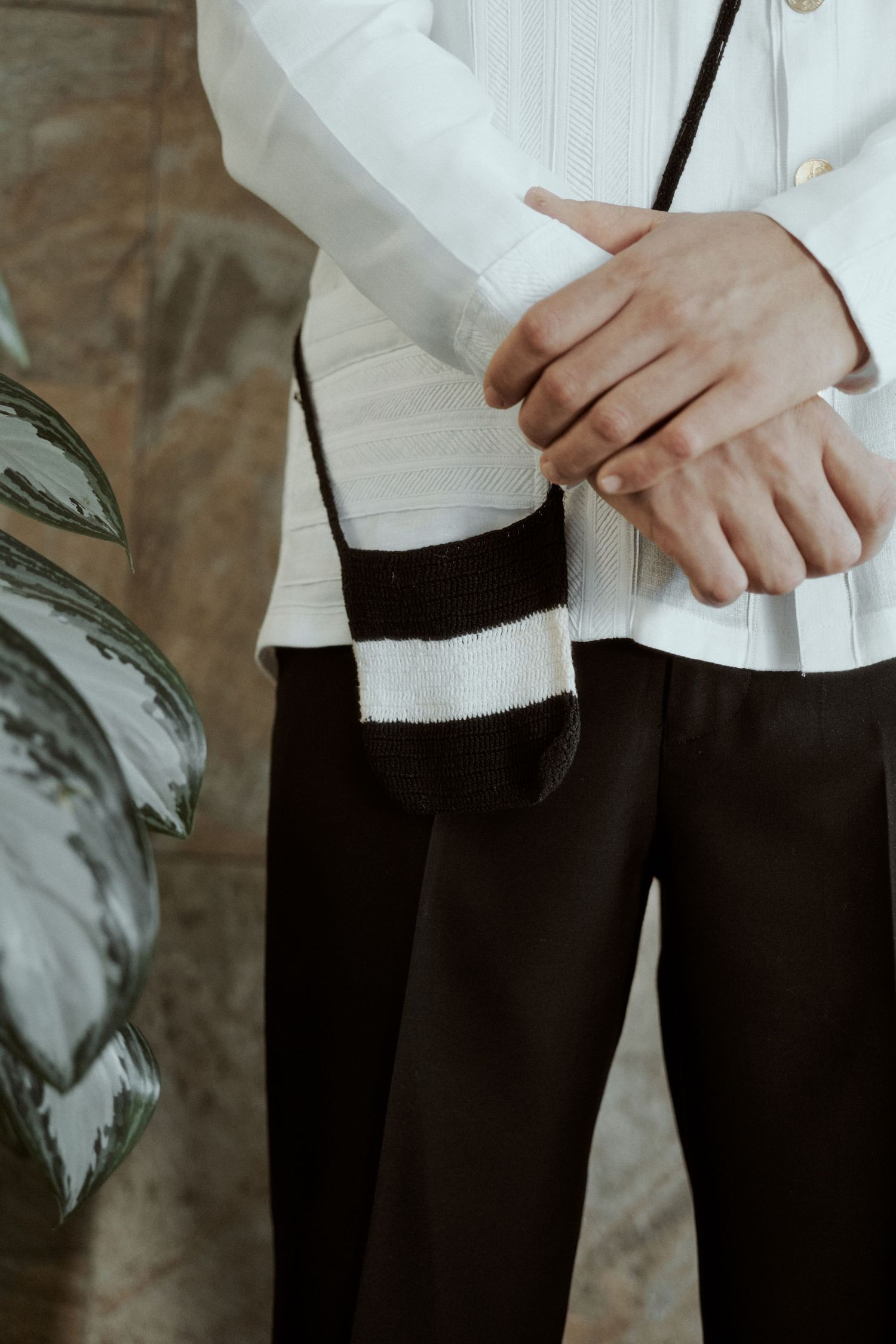 Close-up of formal attire showing white barong and black pants with traditional details.