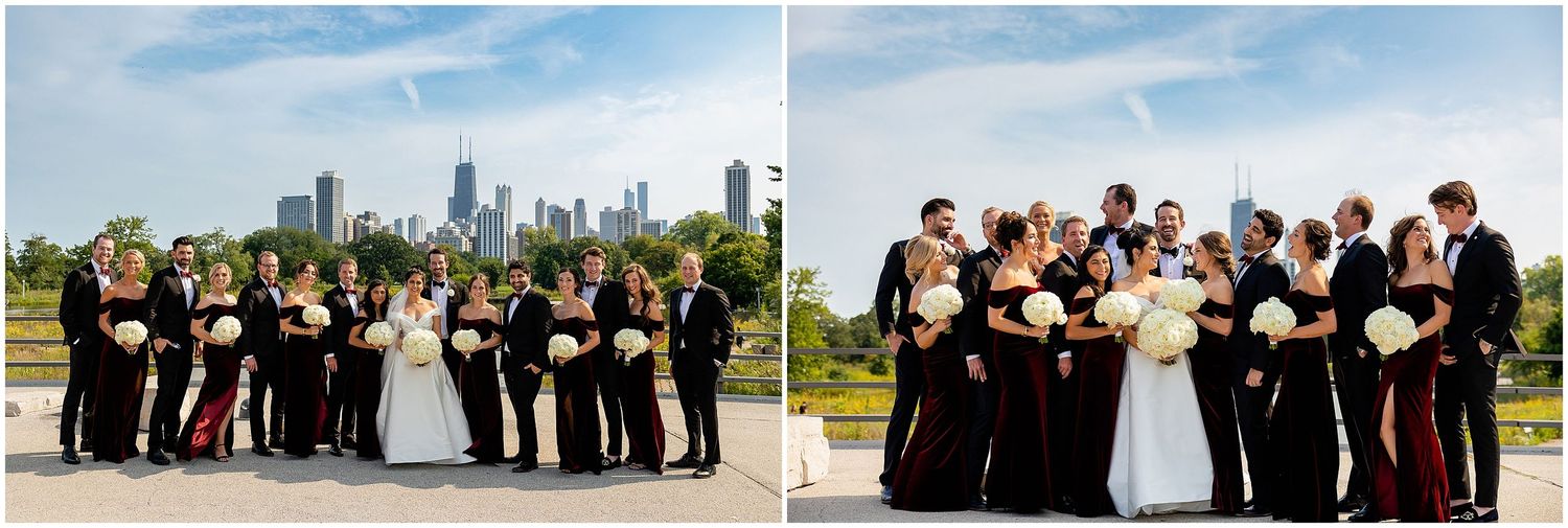 Wedding party in black and white attire poses with city skyline backdrop.