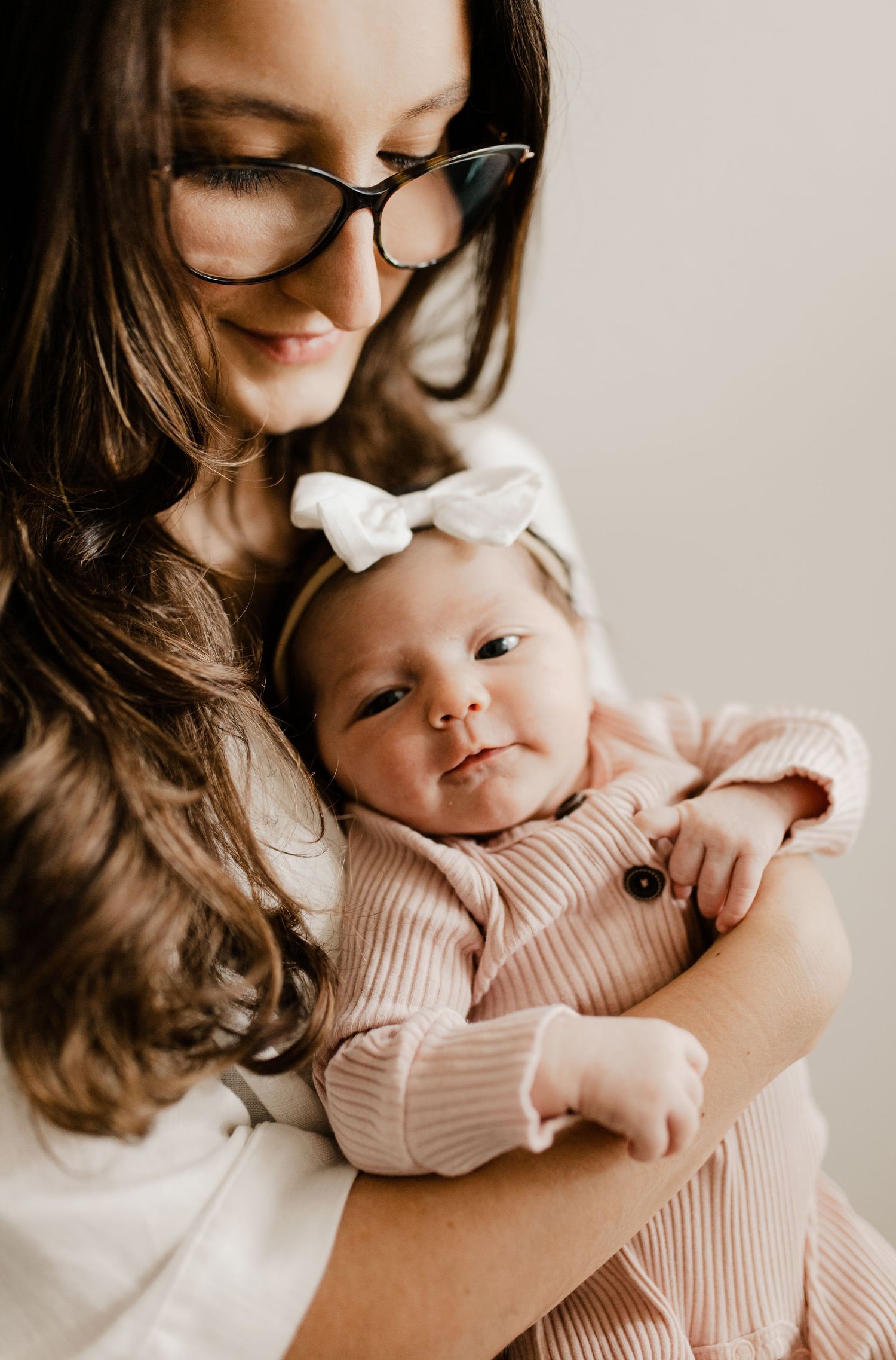 Lifestyle newborn photography session showing gentle moments in soft natural light.