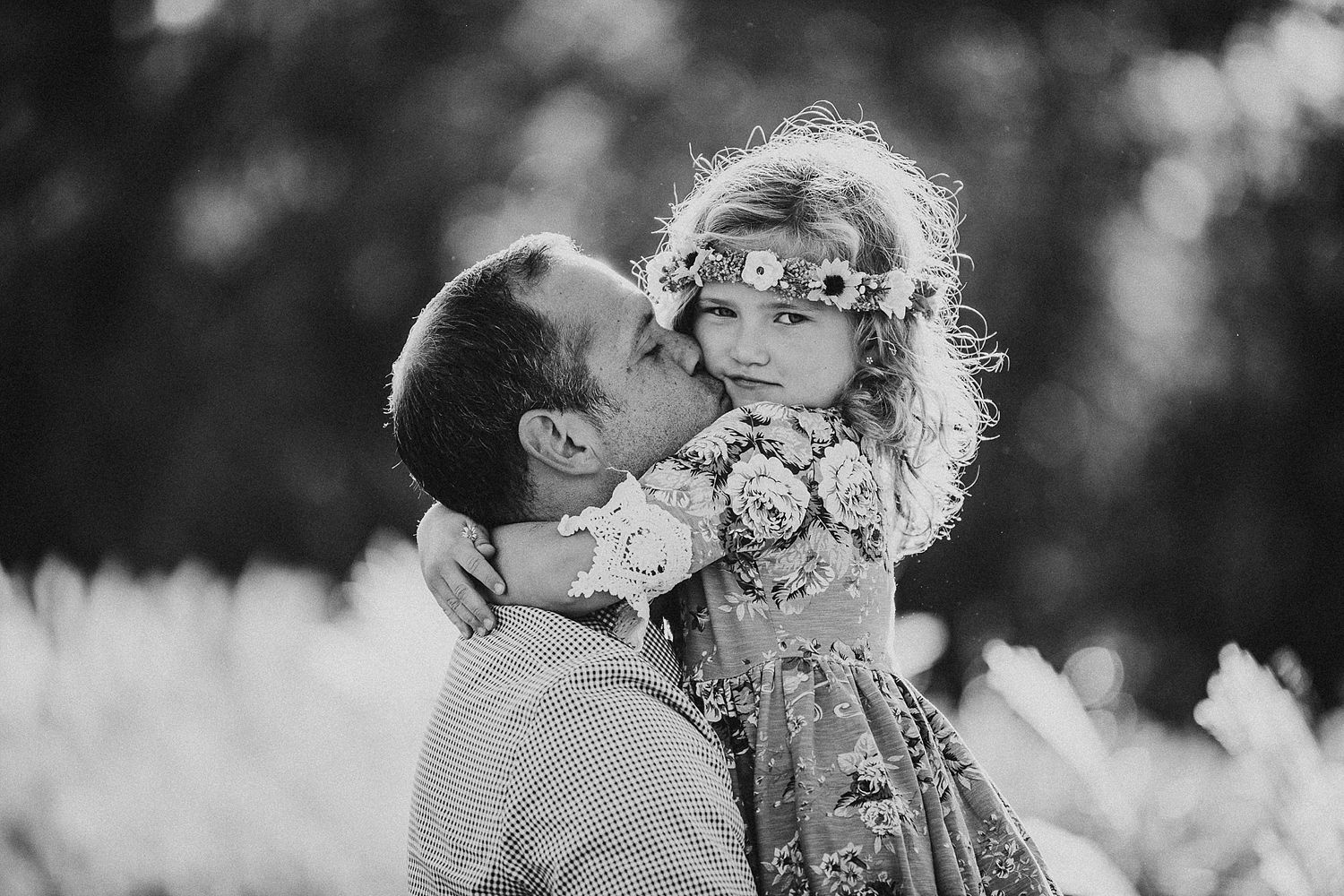 A tender black and white portrait moment in a flower field.