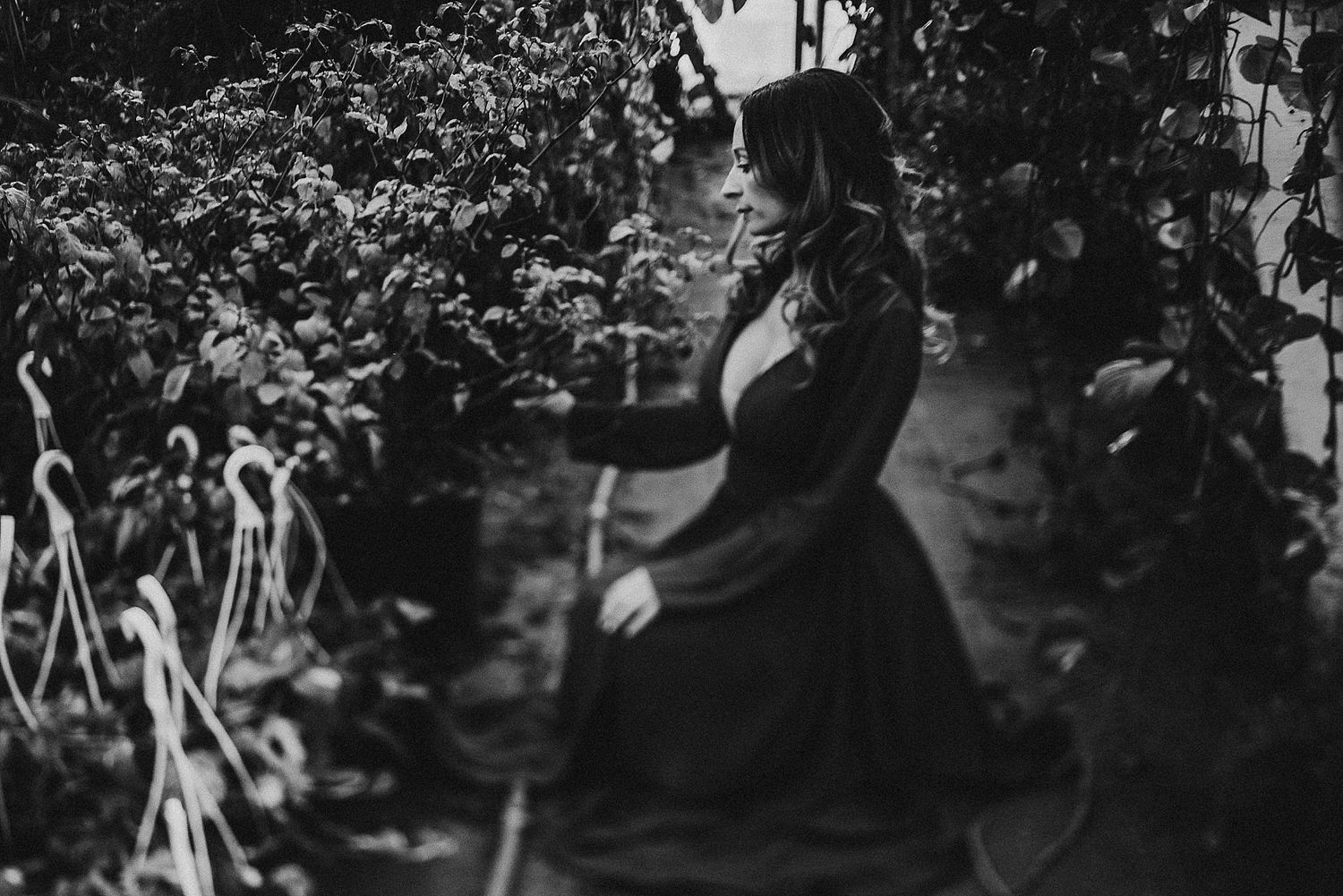 Silhouette of a woman in a flowing dress dancing gracefully in a garden setting.
