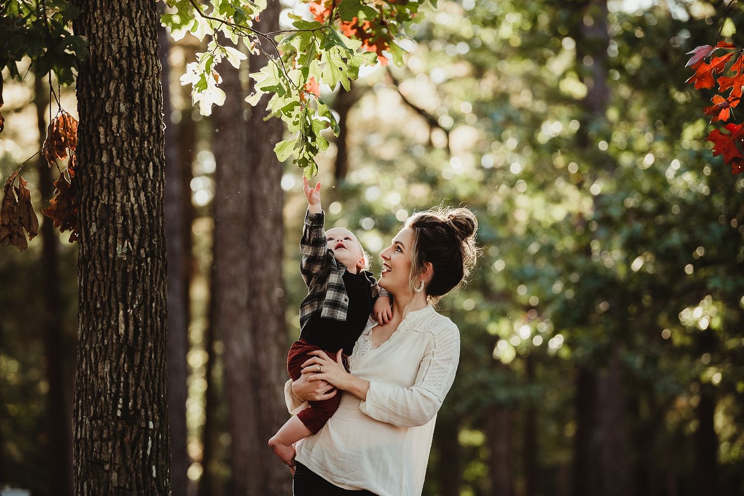 Joyful moment captured between parent and child among blooming trees.