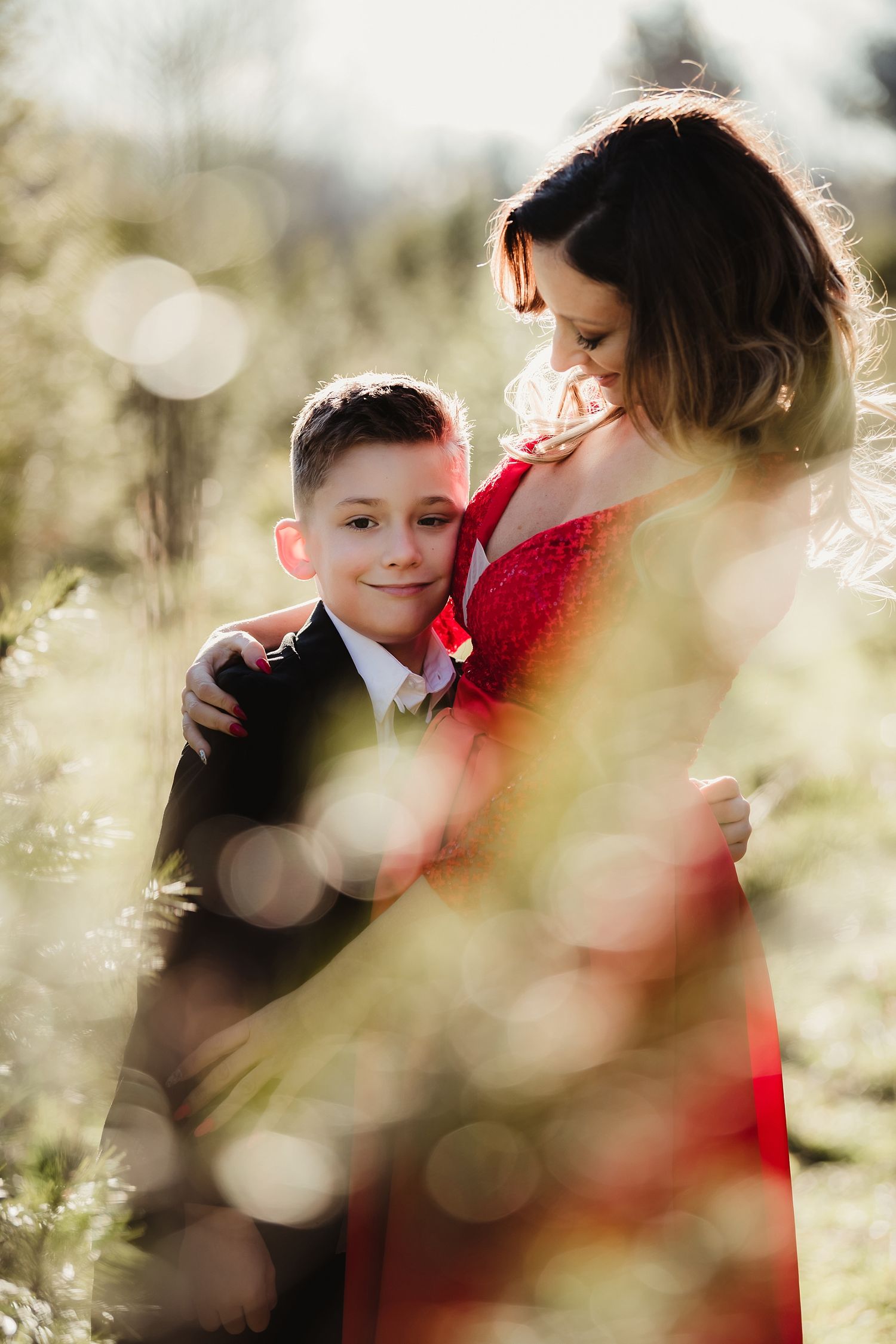 A tender moment captured between parent and child in soft sunlit bokeh.