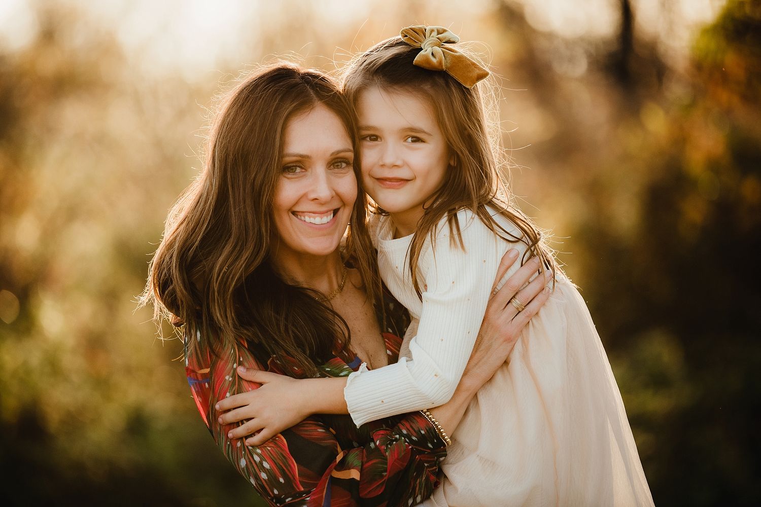 Warm sunset portrait capturing embrace and genuine smiles.