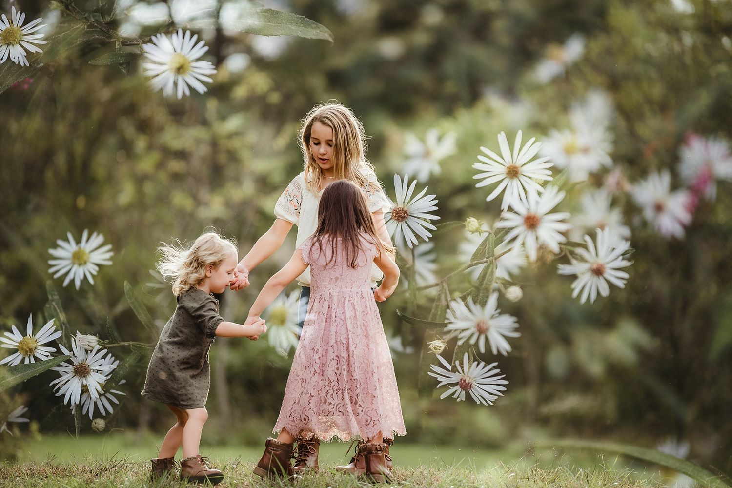 Two people dance together in a field of oversized daisies on a bright summer day.