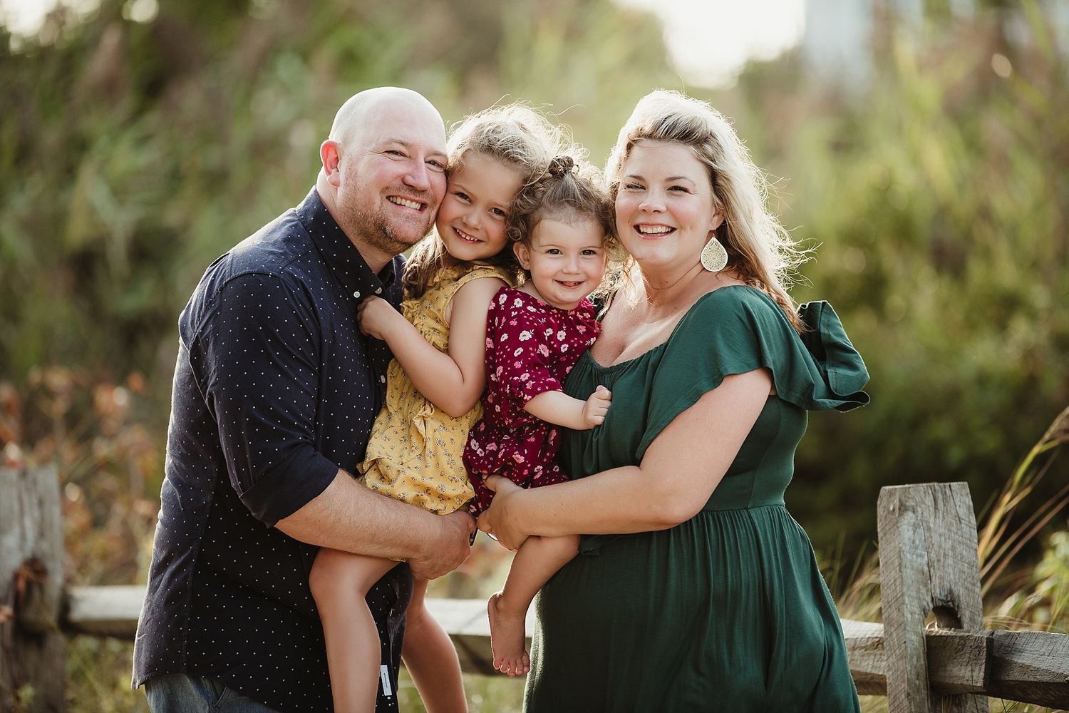A happy family shares warm embraces and laughter outdoors.