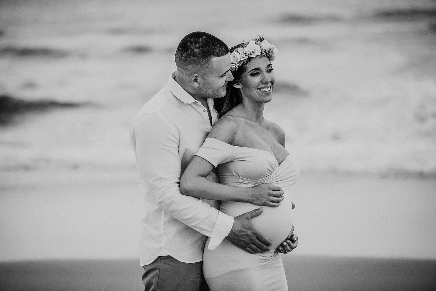 Romantic maternity photo session on the beach in black and white.
