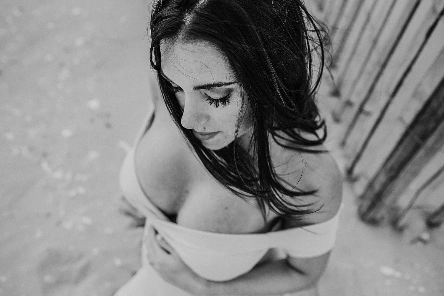 Artistic black and white portrait of woman with flowing dark hair.
