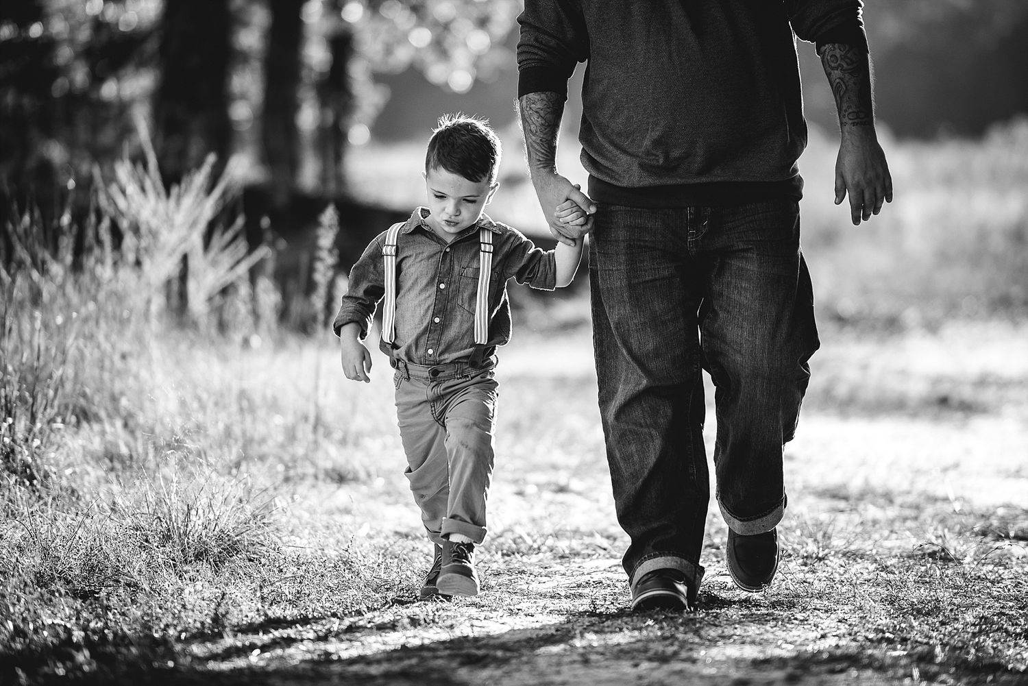 A monochrome image of a walk together along a forest path.