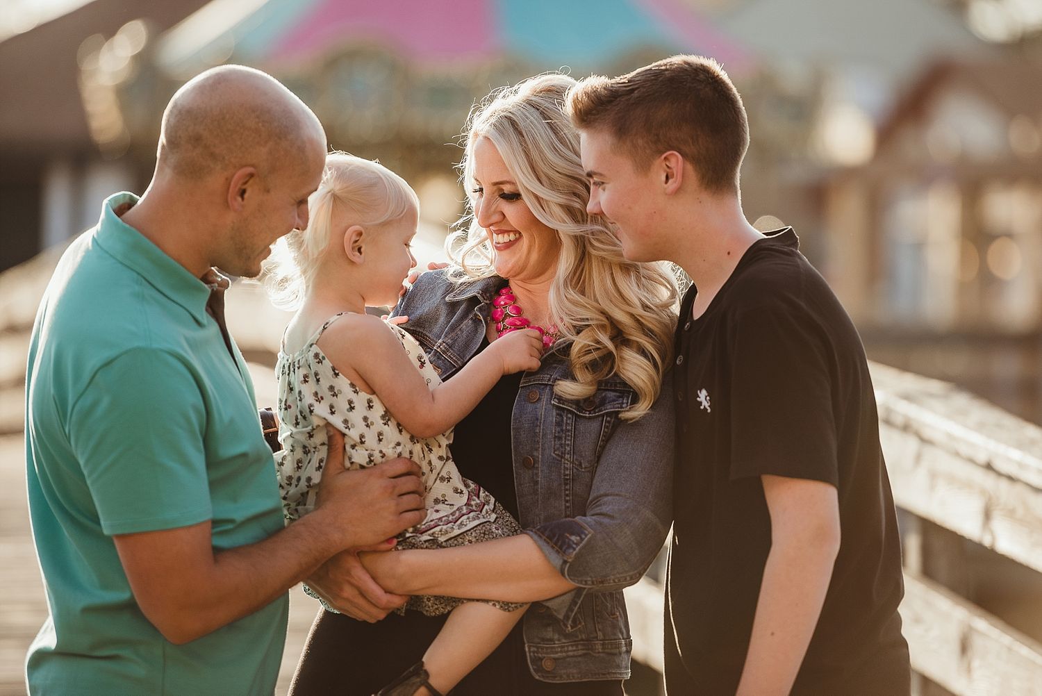 Group sharing tender moment together outdoors during golden hour.