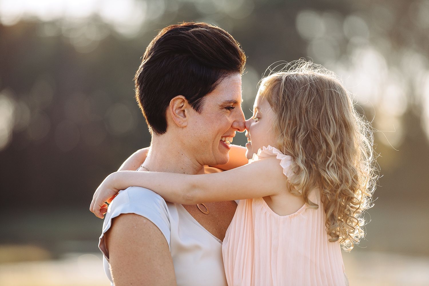 Two people sharing an intimate moment in warm sunset lighting.