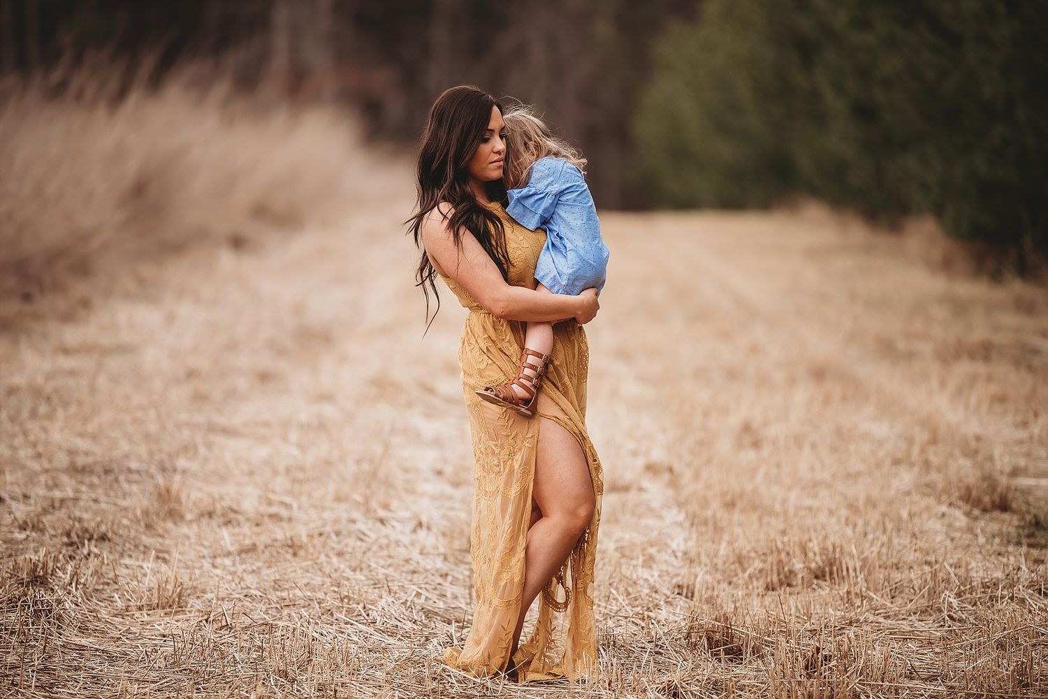Intimate portrait in a golden field during sunset hour.