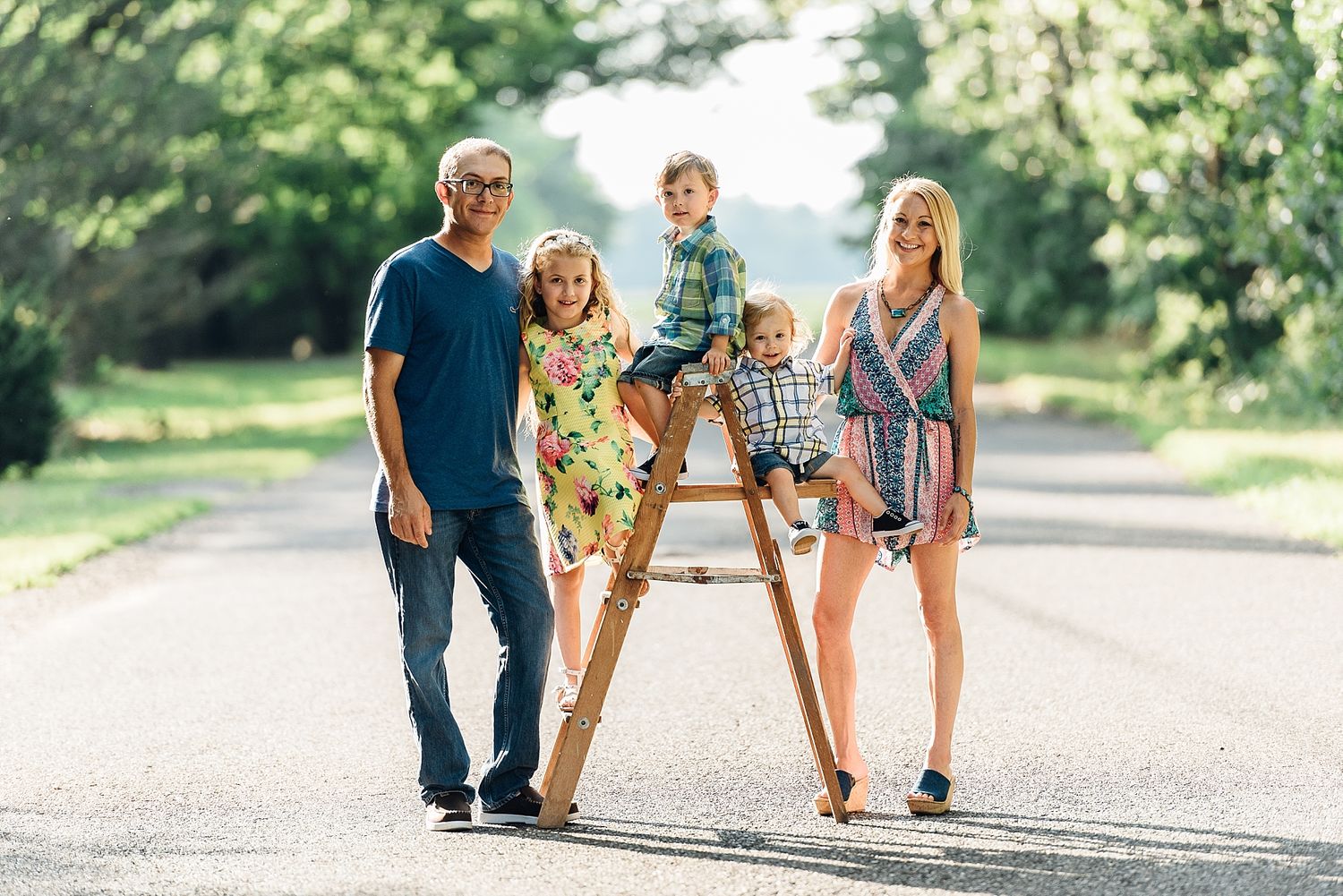 A happy family enjoying a casual stroll together on a sunny paved path.