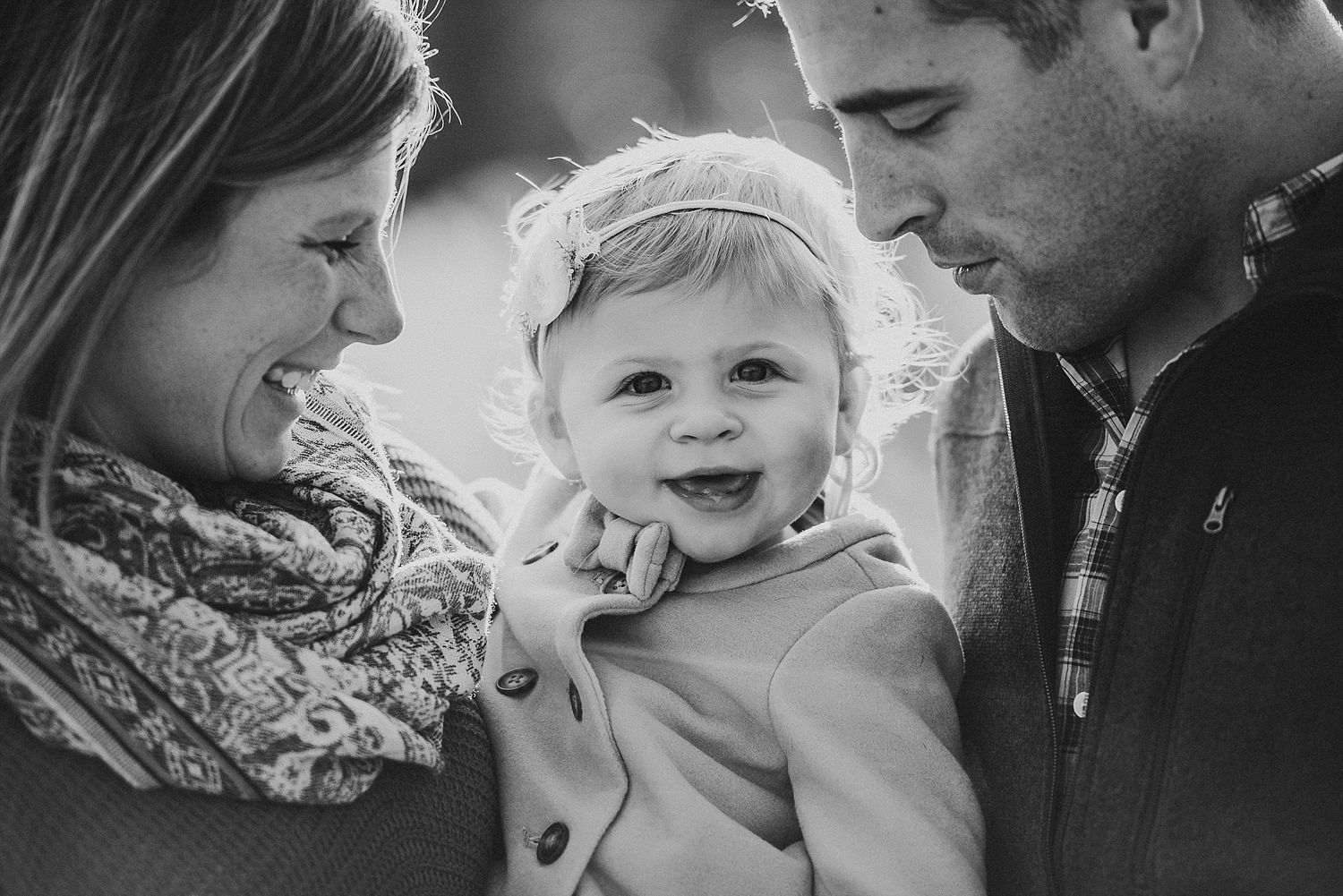 Intimate black and white family portrait captures joyful moment together.